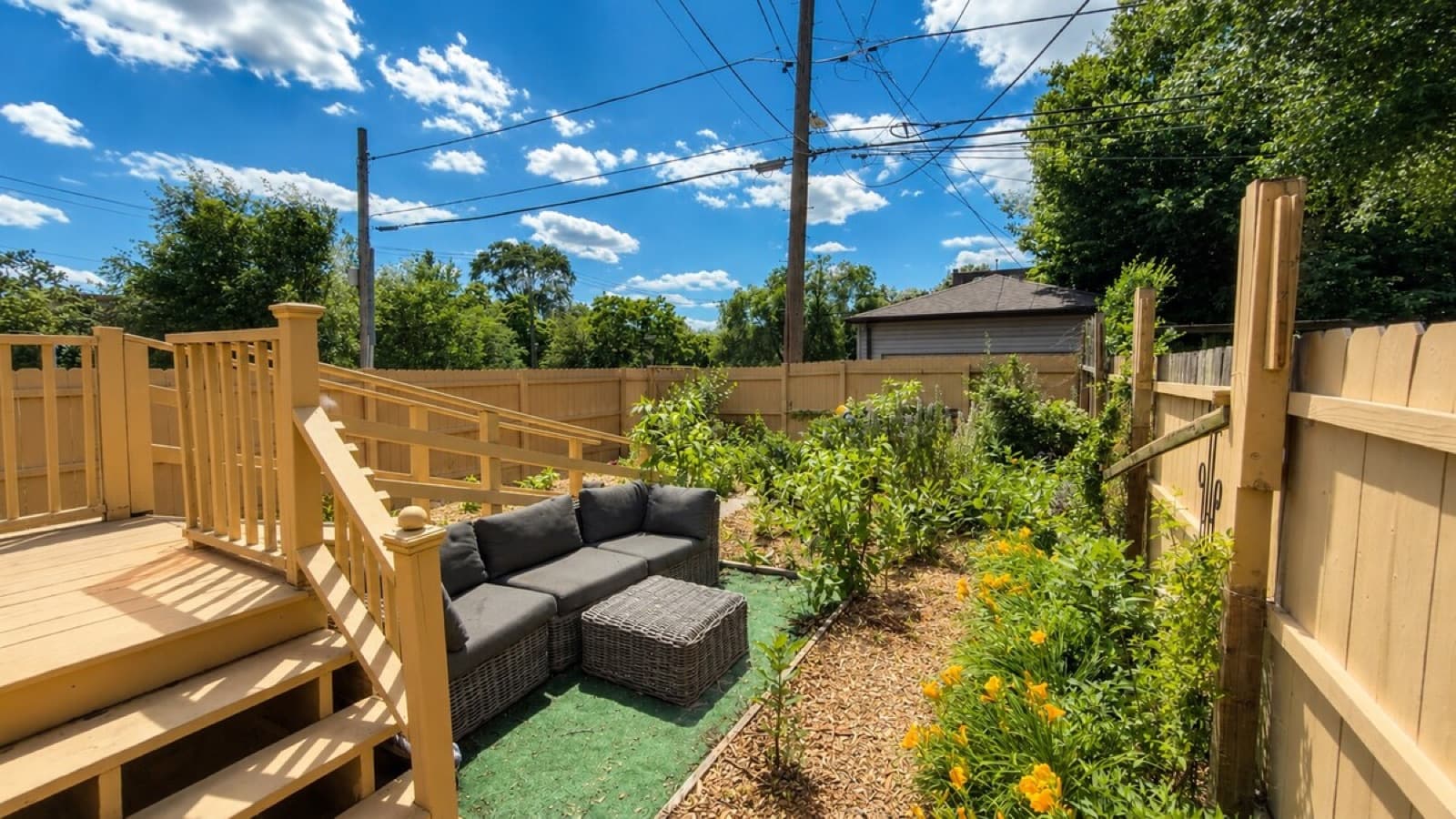 Backyard deck, fence, and seating area after exterior reset