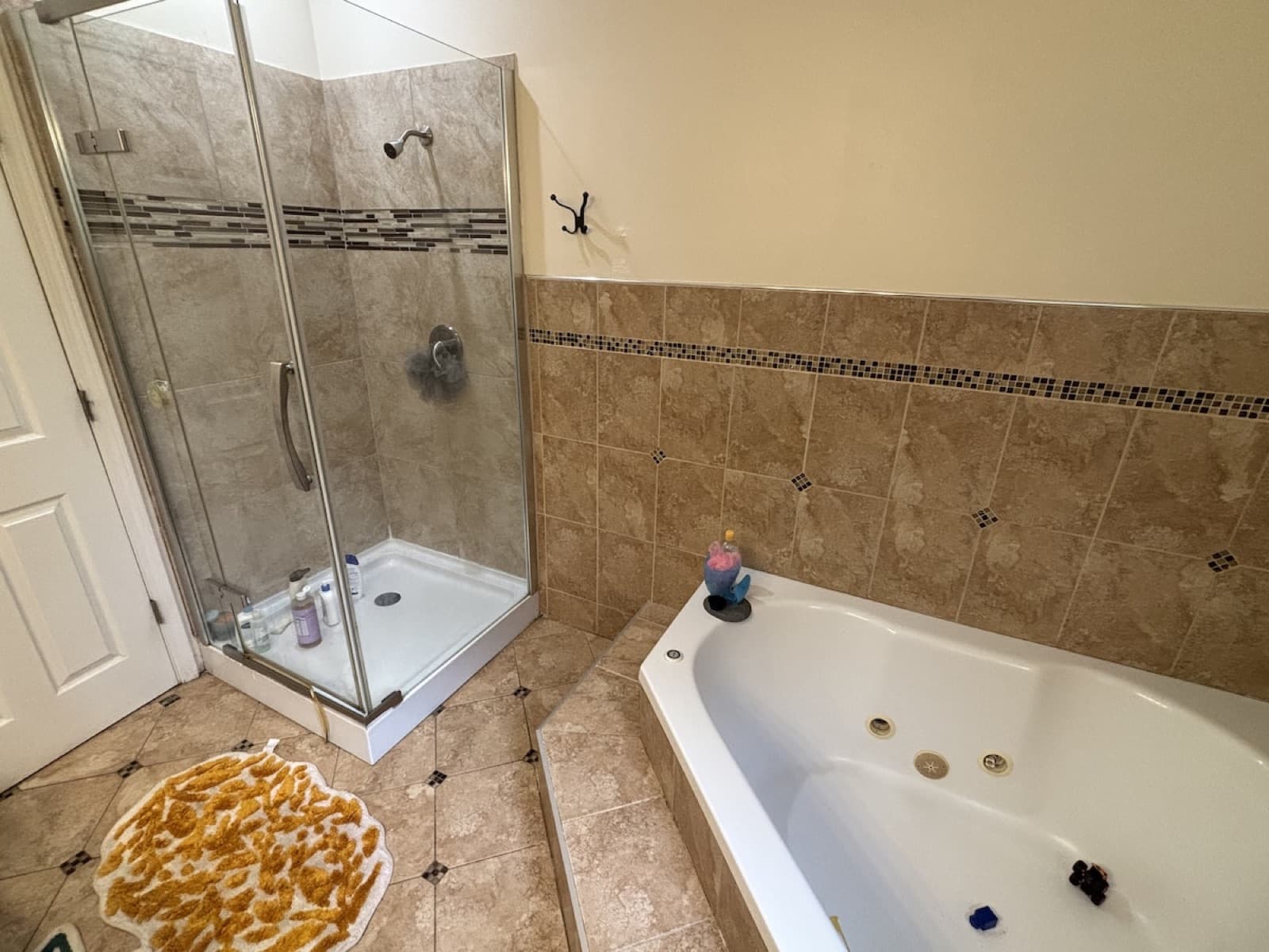 Bathroom with tiled walk-in shower and jetted tub after finish work