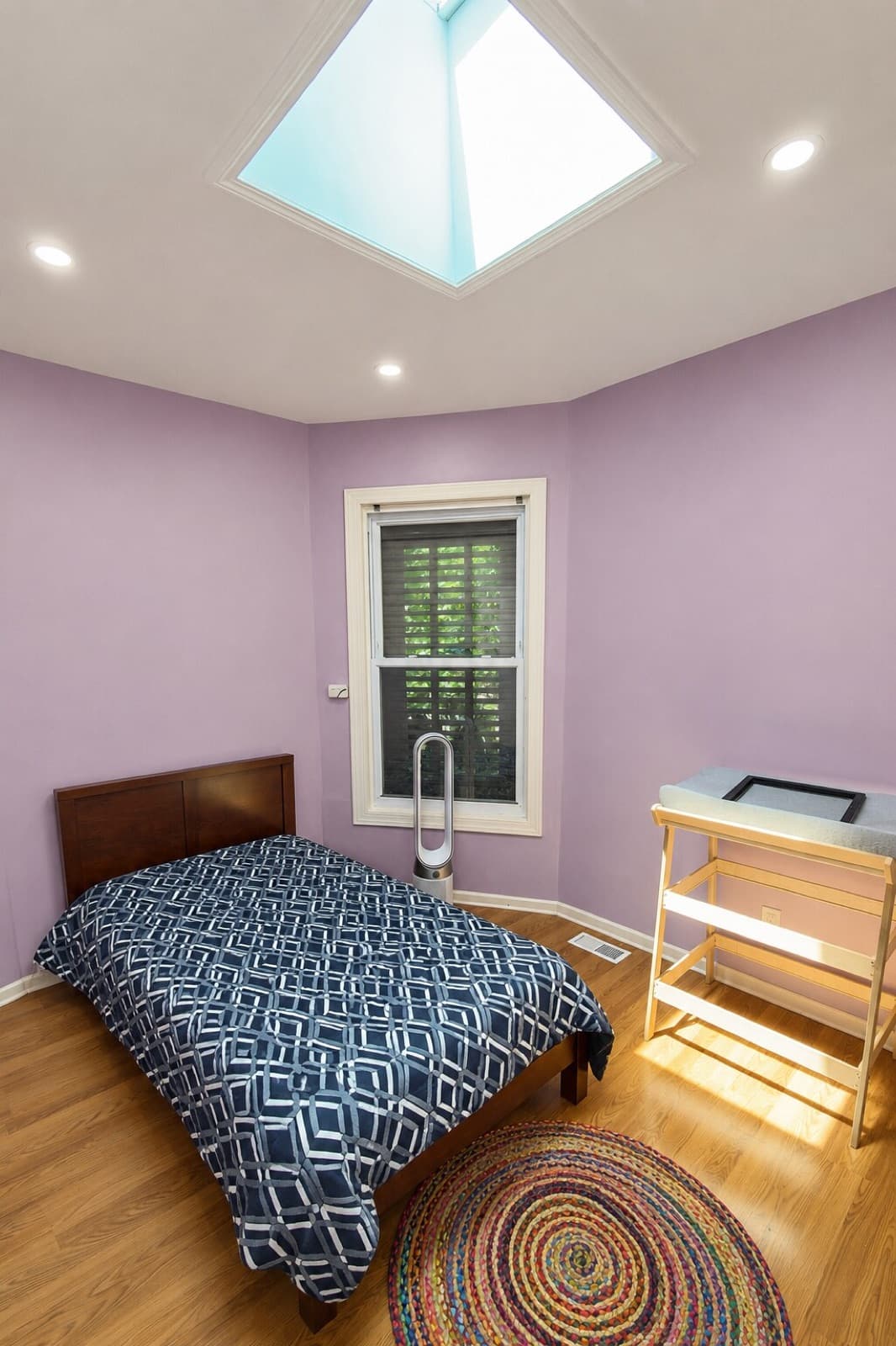 Bright bedroom with skylight, new paint, and cleaned floors