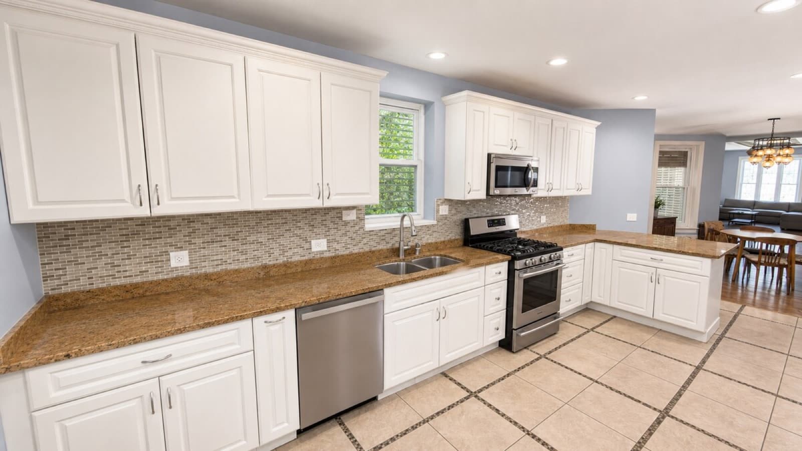 Rent-ready kitchen with white cabinets, granite counters, and stainless appliances